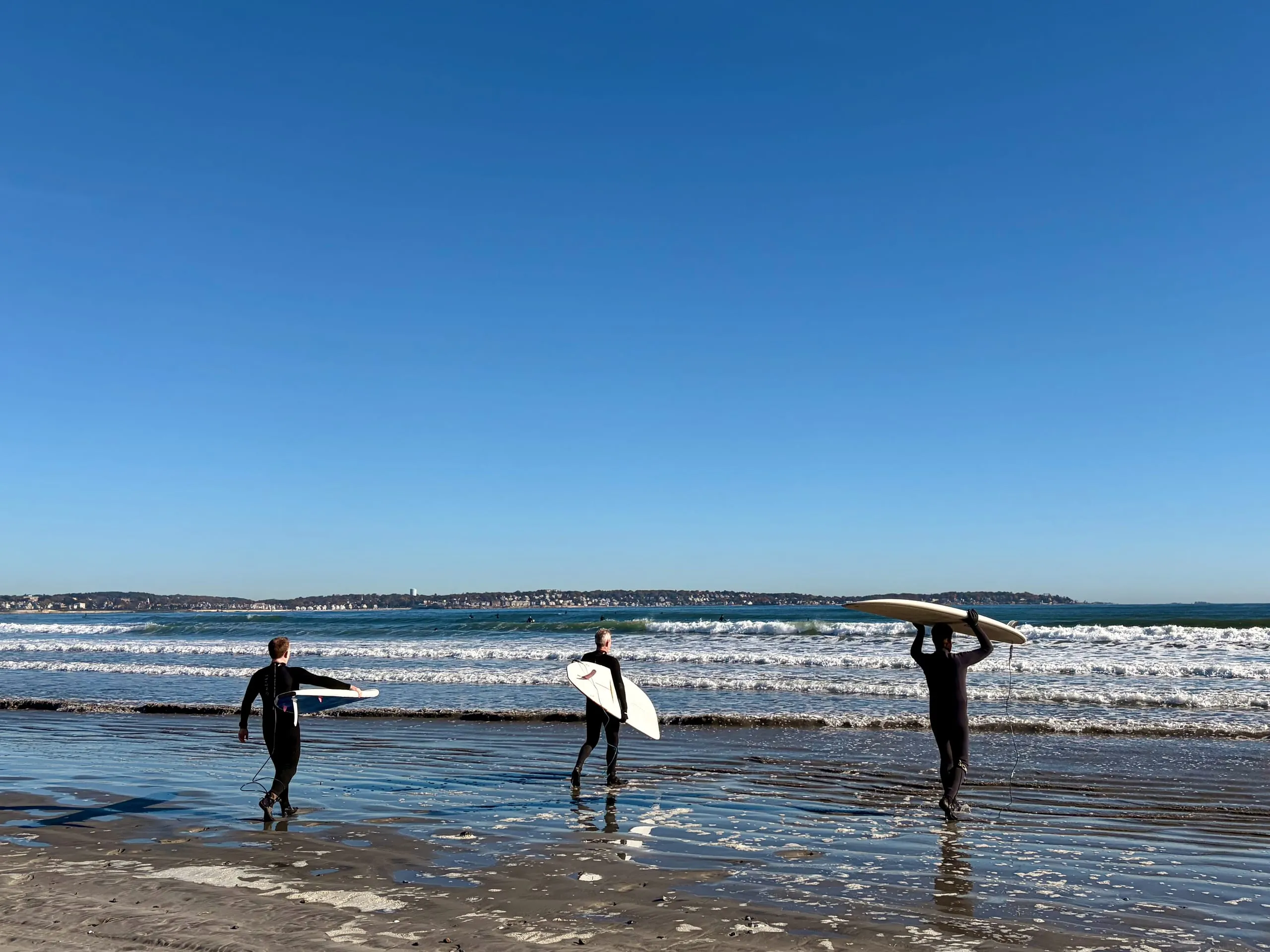 Surfers walking out at Nahant